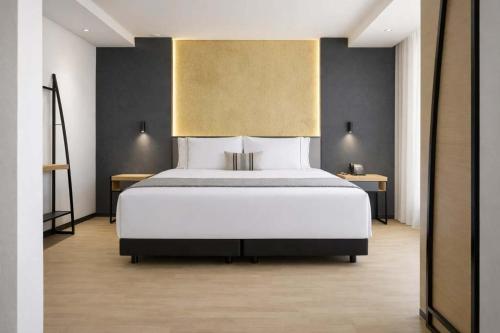 a bedroom with a large white bed in a room at Hotel Catedral in Mexico City