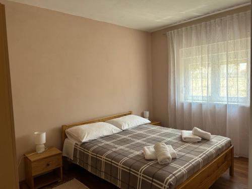 a bedroom with a bed with two towels on it at Kuća za odmor - Snowwhite in Smoković