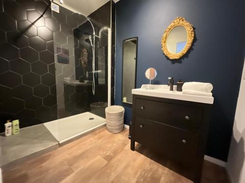 a bathroom with a sink and a shower at À La Cour de Ribeauvillé avec garage in Ribeauvillé