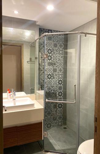 a bathroom with a shower and a sink at Caracole homestay - 2BR with cozy balcony garden in Kim Quan