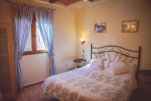 a bedroom with a bed and a window at La Vall de Silvestre in Mas de Barberáns