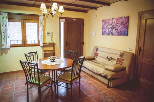 a living room with a table and a couch at La Vall de Silvestre in Mas de Barberáns