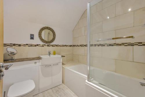a bathroom with a shower and a toilet and a sink at 3 Bed in Dunwich oc-slh in Dunwich