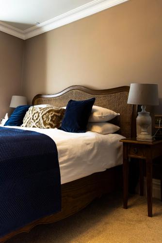 a bedroom with a bed with blue and white pillows at Old Town House, Margate in Margate