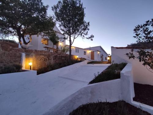 a driveway leading up to a house at night at Casal da serra da Arrábida in Palmela
