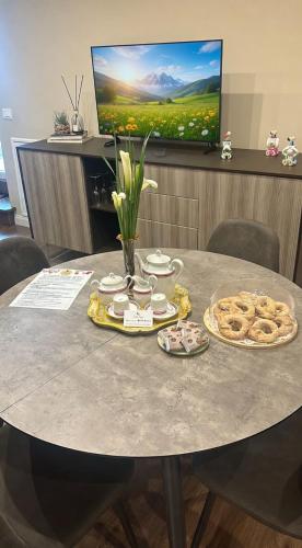 a table with cookies and a tv in a room at Relaxing charm alla Radeca in Frosinone