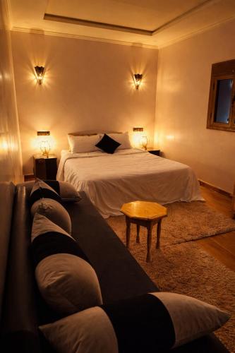 a hotel room with a bed and a couch at Chez BABAYO BY DADES in Zaouïet Sidi Daoud