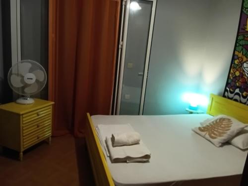 a bedroom with a bed with a mirror and a dresser at Kalli's View in Evdilos