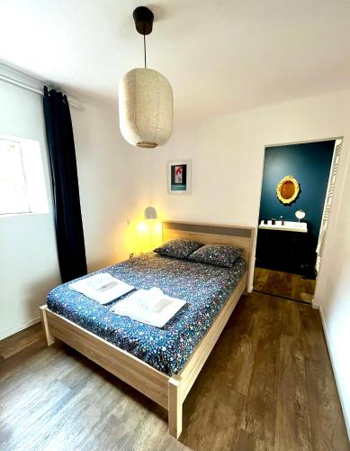 a bedroom with a bed and a desk in it at À La Cour de Ribeauvillé avec garage in Ribeauvillé