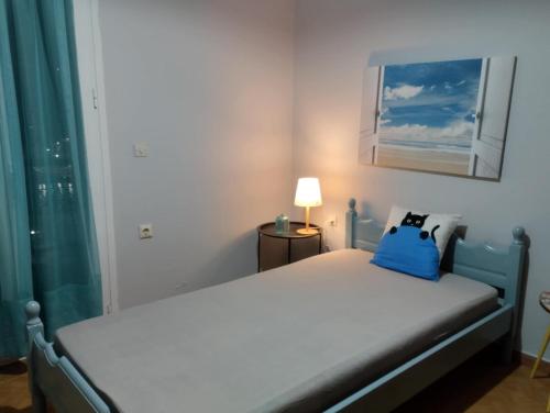 a bedroom with a bed with a blue bag on it at Kalli's View in Evdilos