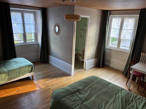 a bedroom with a bed and a mirror in it at Lods Hotel de France in Lods