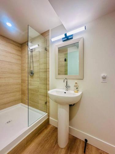 a bathroom with a sink and a shower at Gorgeous Ocean and Mountain View King Suite in Bowen Island