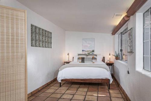 a white bedroom with a bed and a window at Sequoia Riverfront House With Beach Access in Three Rivers