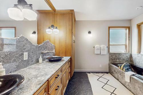 a bathroom with a sink and a large mirror at Leavenworth Mountain, Golf Course, 3br 4 ba in Leavenworth