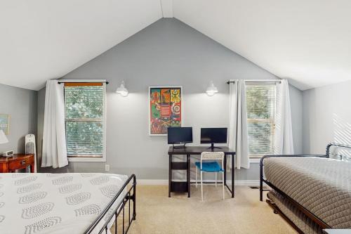 a bedroom with a bed and a desk with a computer at Leavenworth Mountain, Golf Course, 3br 4 ba in Leavenworth