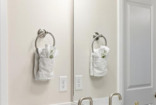 a bathroom with two towels hanging on a mirror at The Treehouse in Escondido in Washington