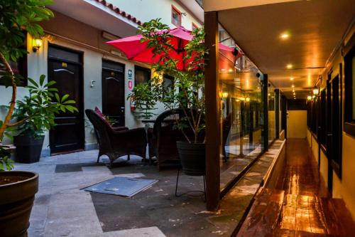 a building with a patio with chairs and plants at Hotel Royal Qosqo in Cusco