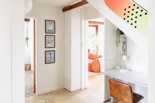 a home office with an orange chair and a desk at Epic Apartment in Downtown Stowe in Stowe