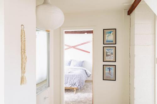 a bedroom with a bed and a clock on the wall at Epic Apartment in Downtown Stowe in Stowe