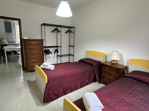 a bedroom with two beds and a dresser at La rampata in Porretta Terme