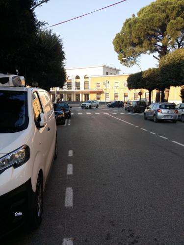 a white car parked on the side of a street at B&b La Ferrovia in Benevento