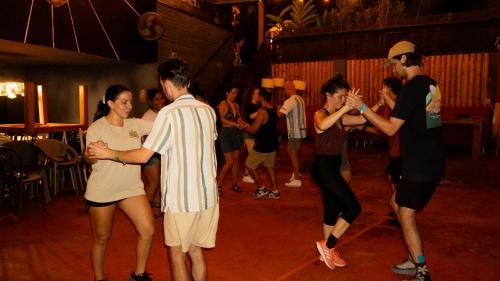 a group of people dancing at a party at Viajero Cali Hostel & Salsa School in Cali