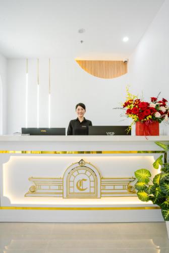 a man sitting at a desk in a room at La Cheminee Boutique Apartment in Phú Quốc
