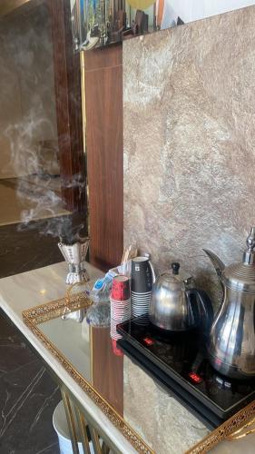a counter top with two pots and pans on it at Golden New Alareen-جولدن العرين أبها in Abha