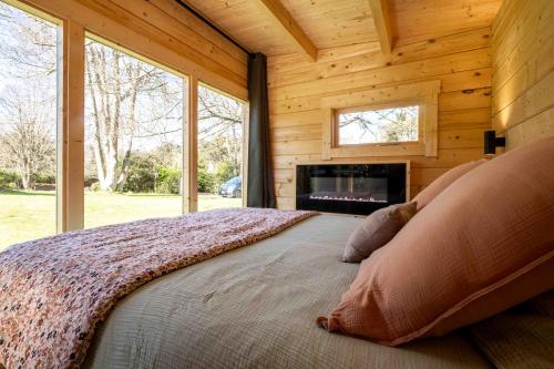 a bedroom with a large bed in a log cabin at EDEN LOCQUIREC l Flow Breathe & SPA l La Chambre d'Hôtes réinventée in Locquirec