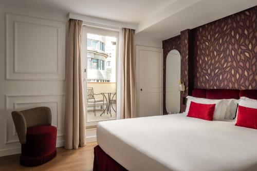 a hotel room with a large bed and a window at BYPILLOW Callao in Madrid