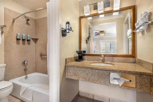 a bathroom with a sink and a tub and a toilet at Best Western Tradewinds in Morro Bay