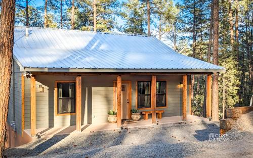 a small house in the middle of a forest at T-Post - A Beautiful New-Build with Treetop Deck in Ruidoso