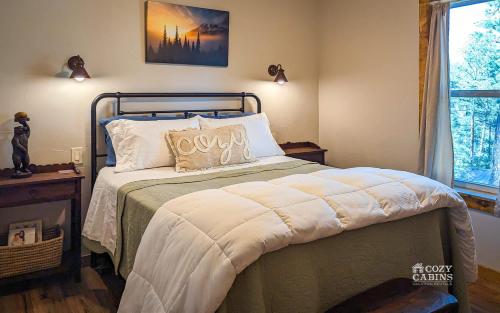 a bedroom with a bed and a window at T-Post - A Beautiful New-Build with Treetop Deck in Ruidoso