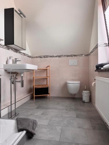 a bathroom with a sink and a toilet at Ferienwohnung Klahn Neue Tiefe in Neue Tiefe Fehmarn