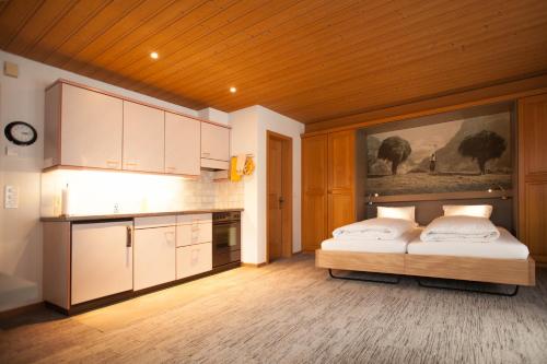a kitchen with two beds in a room at Chalet Schwendiboden in Grindelwald