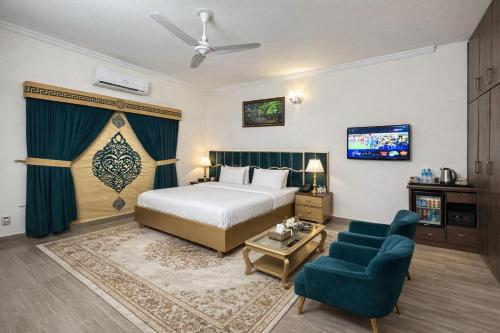a hotel room with a bed and a tv at Capital Family Lodges Islamabad in Islamabad