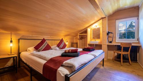 a bedroom with a large bed in a room at Naturfreunde Hostel Grindelwald in Grindelwald