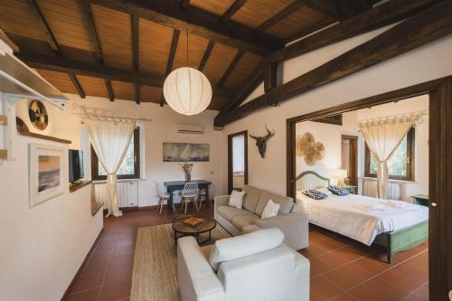 a living room with a bed and a couch at Agriturismo Pimpinnacolo in Porto Ercole