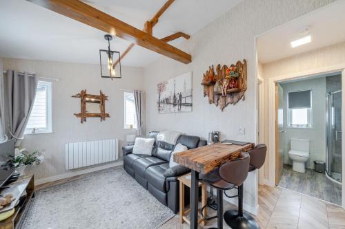 a living room with a couch and a table at 1 Bed Cabin - Sleeps 2 - Pets - 2 Min To Beach in Bridlington