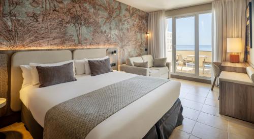 a hotel room with a bed and a view of the ocean at Ilunion Fuengirola in Fuengirola