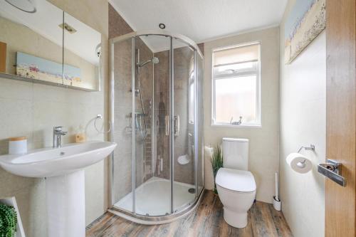 a bathroom with a shower and a toilet and a sink at 2 Bed Cabin - Sleeps 4 - Pets - 5 min to Beach in Bridlington