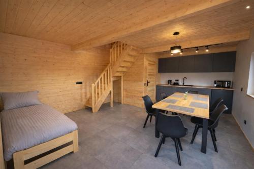 a room with a bed and a table and chairs at Noclegi Przy Karczmie in Makowiec