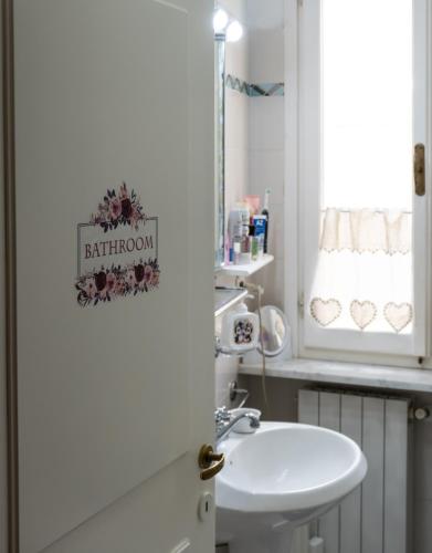 a bathroom with a sink and a white toilet at Tuscan retreat in Orciatico