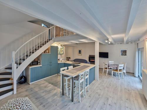 a kitchen and dining room with a staircase in a house at Haus Eifelsonne in Ramscheid