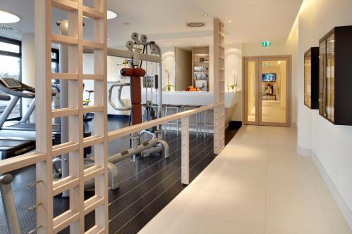 a fitness room with a treadmill and a gym at Radisson Blu Hotel, Hamburg in Hamburg