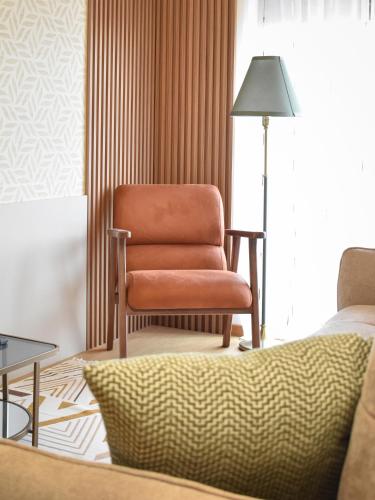 a living room with a chair and a lamp at Montewave Studio Apartment in Boreti