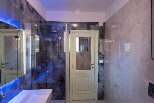 a bathroom with a shower and a sink at Anthyllis Apartment in Alghero