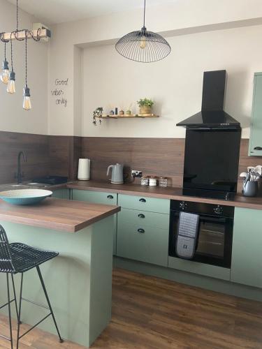 a kitchen with a counter and a stove top oven at Warm Spacious apartment in Pembroke Dock