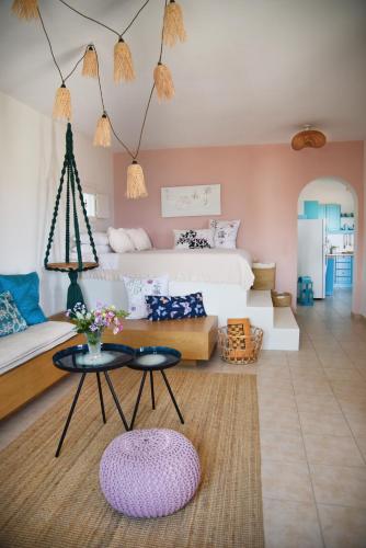 a living room with a bed and a table at Elefthia Syros - Luxury Houses & Suites in Megas Gialos - Nites