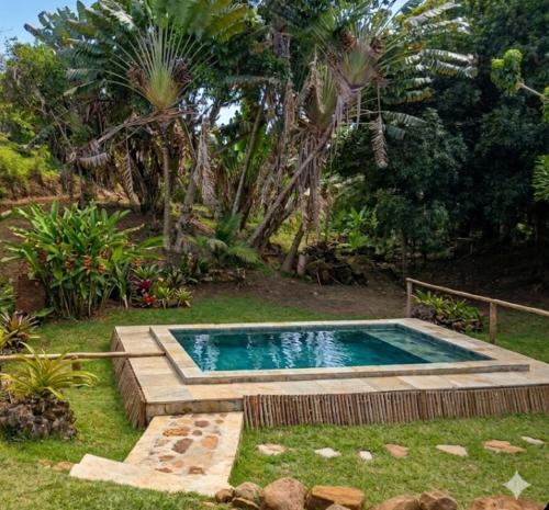 a small swimming pool in a yard with trees at Lambawany in Sainte Marie